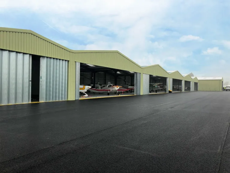 Large steel framed building for an aircraft hangar at Breighton Airfield with full width Wessex doors supplied by Springfield Steel Buildings