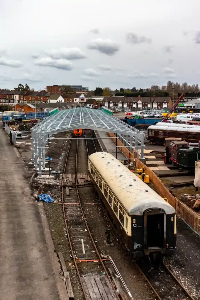 Steel Frame erected for a large Steel Train Shed with a vintage train outside